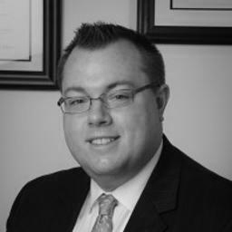 Black-and-white portrait of man in suit and glasses