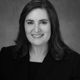 Black-and-white headshot of smiling woman in blazer