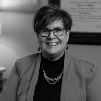 Smiling woman wearing glasses in office setting