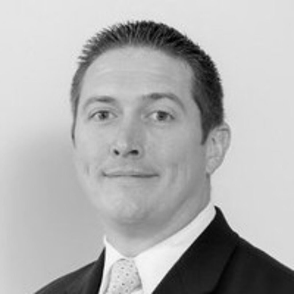 Black-and-white professional headshot of man in suit