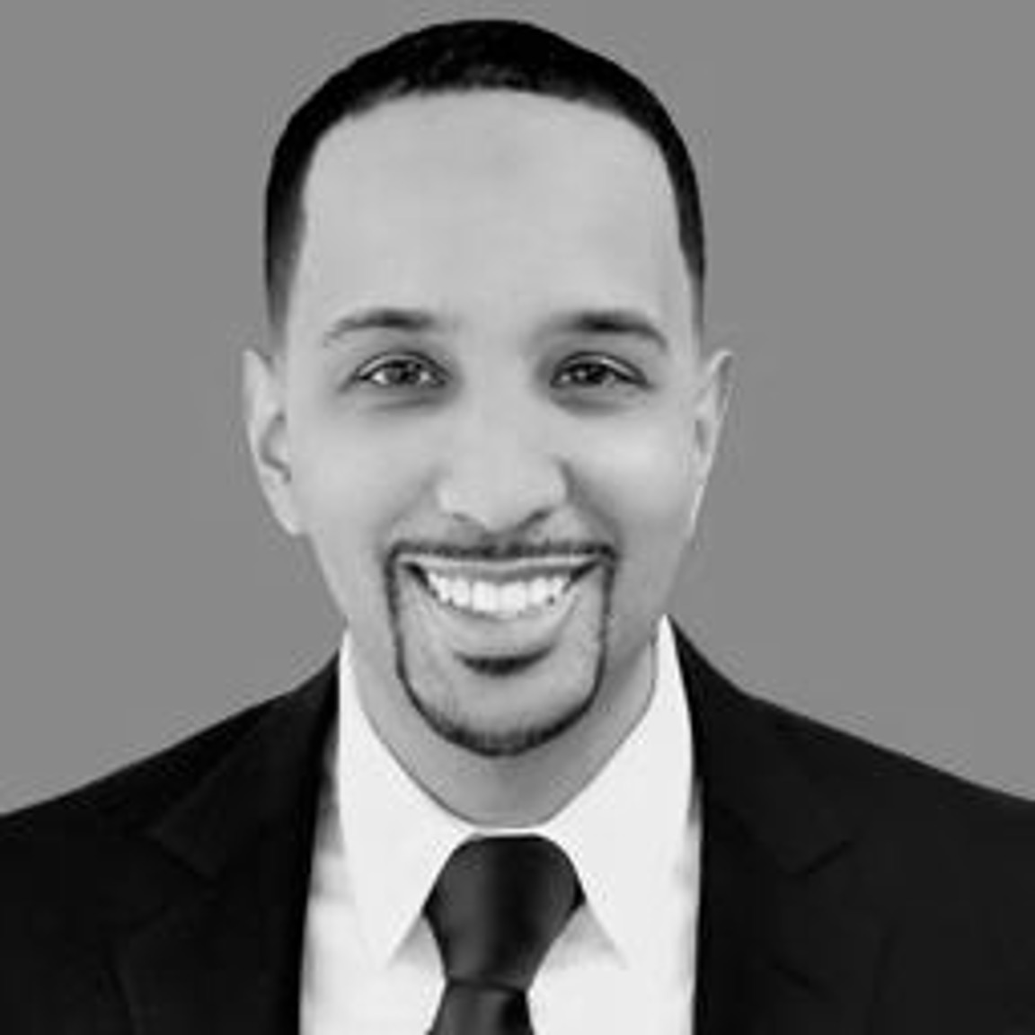 Smiling man in suit and tie headshot