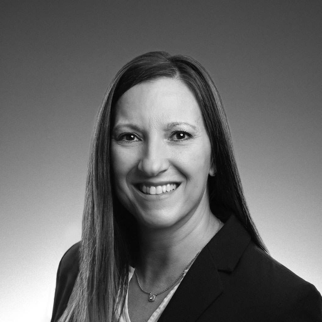 Black-and-white professional headshot of smiling woman