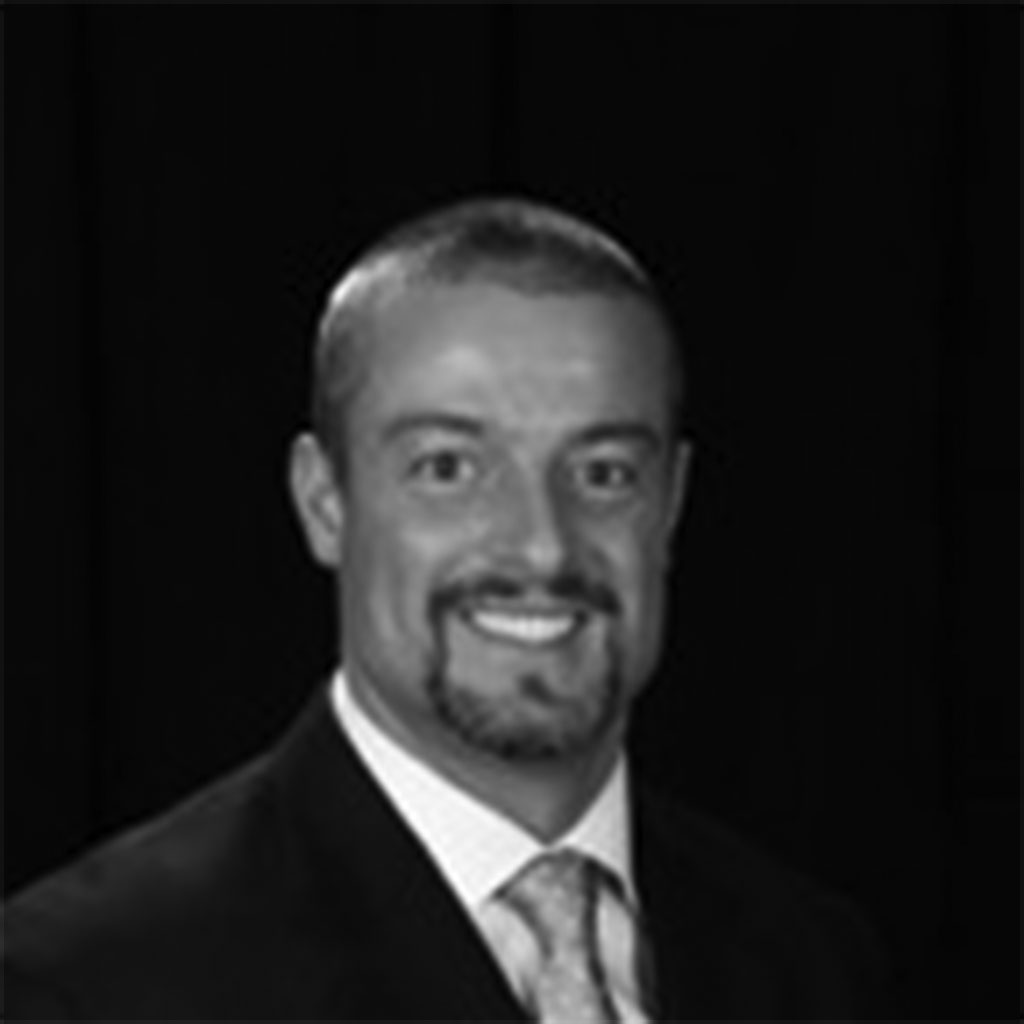Black-and-white portrait of smiling man in suit