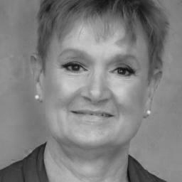 Black-and-white portrait of smiling woman with short hair