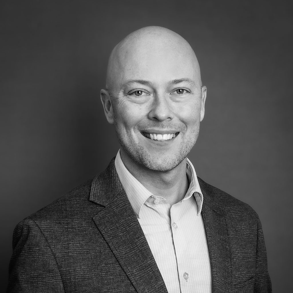 Smiling bald man in business suit portrait