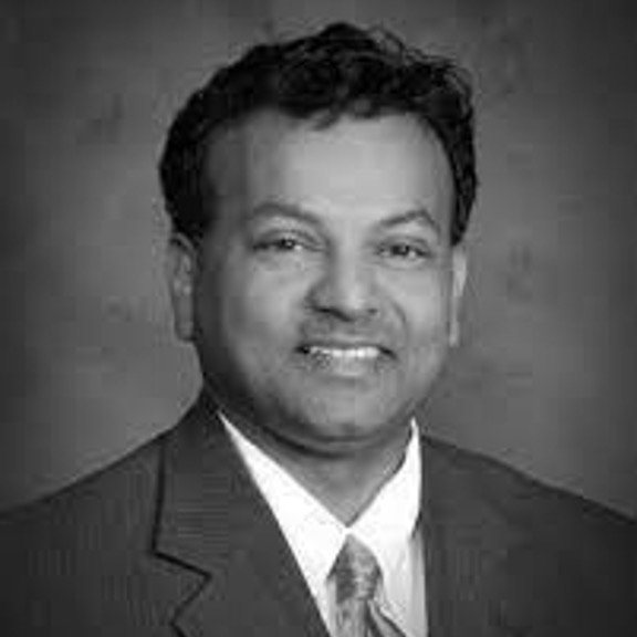 Black-and-white portrait of smiling man in suit