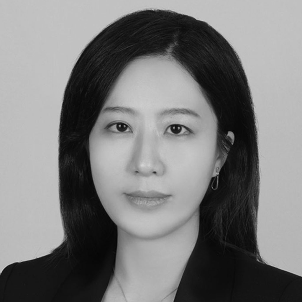 Black-and-white headshot of woman in blazer