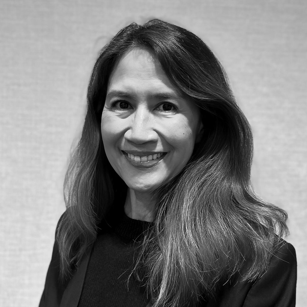 Black-and-white portrait of smiling woman with long hair