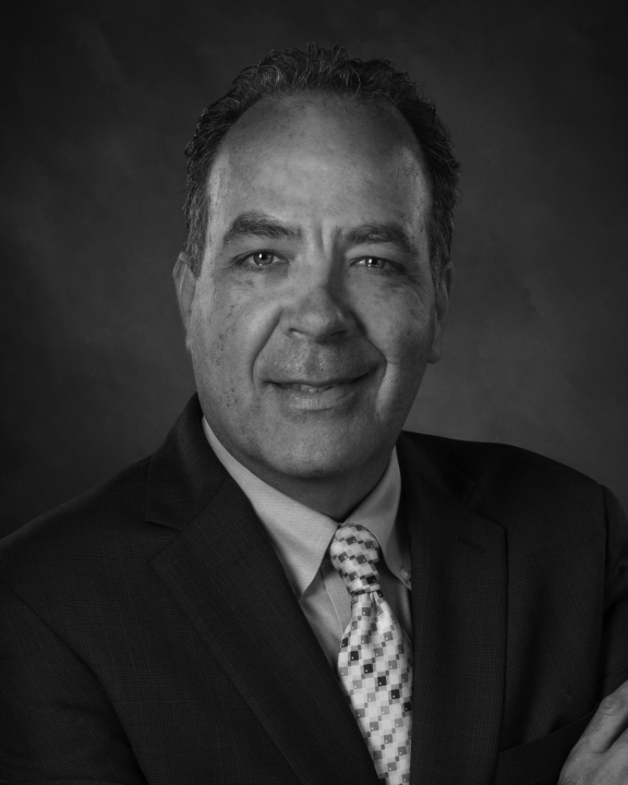 Black-and-white portrait of man in suit and tie