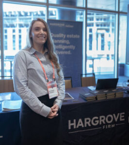 Woman standing at conference booth display table
