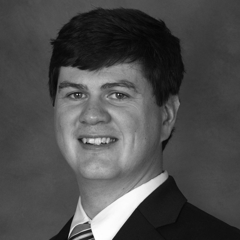 Black and white portrait of smiling man in suit