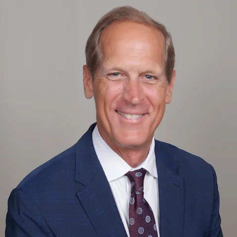 Smiling man in blue suit and tie