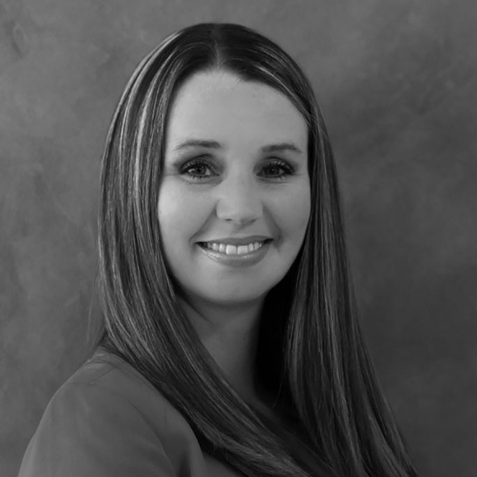 Black-and-white portrait of smiling woman with long hair
