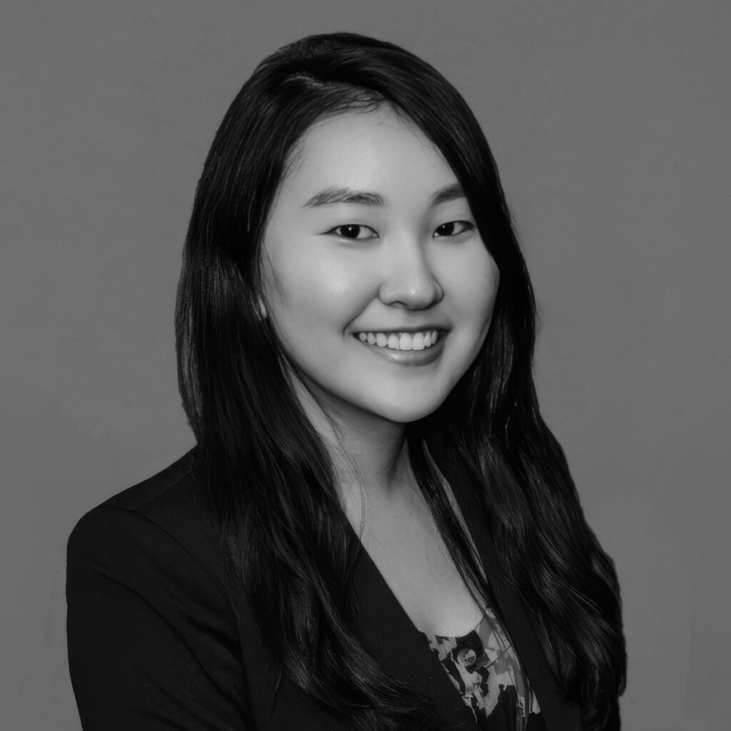 Black-and-white professional headshot of smiling woman