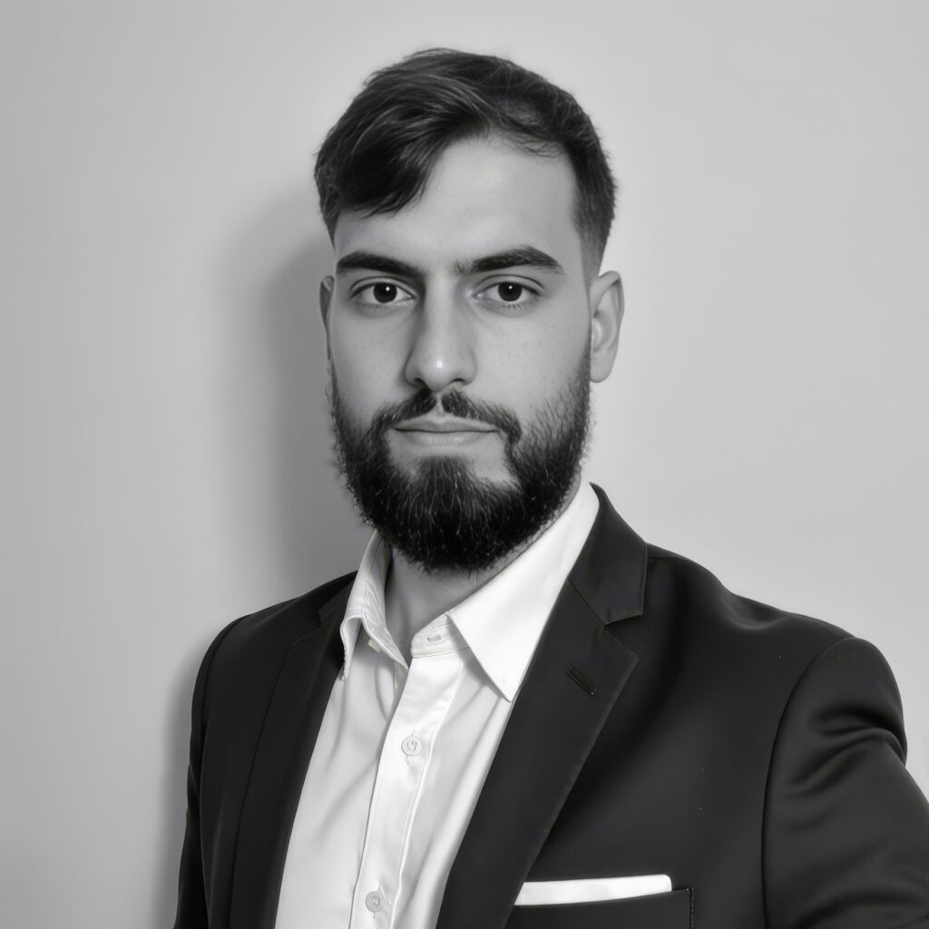 Black-and-white portrait of bearded man in suit