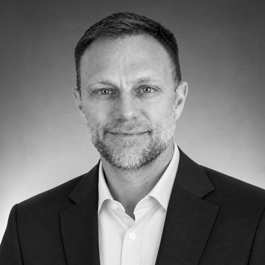 Black-and-white professional headshot of John Redmond