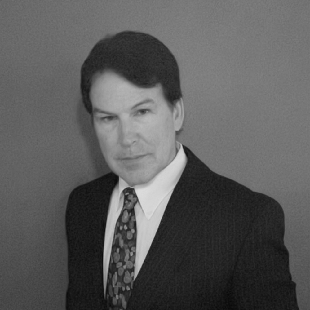 Black-and-white portrait of man in suit and tie