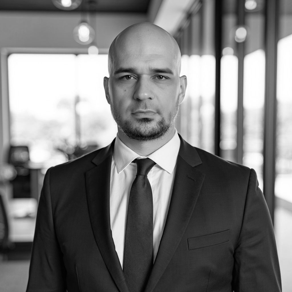 Bald businessman in suit standing in office