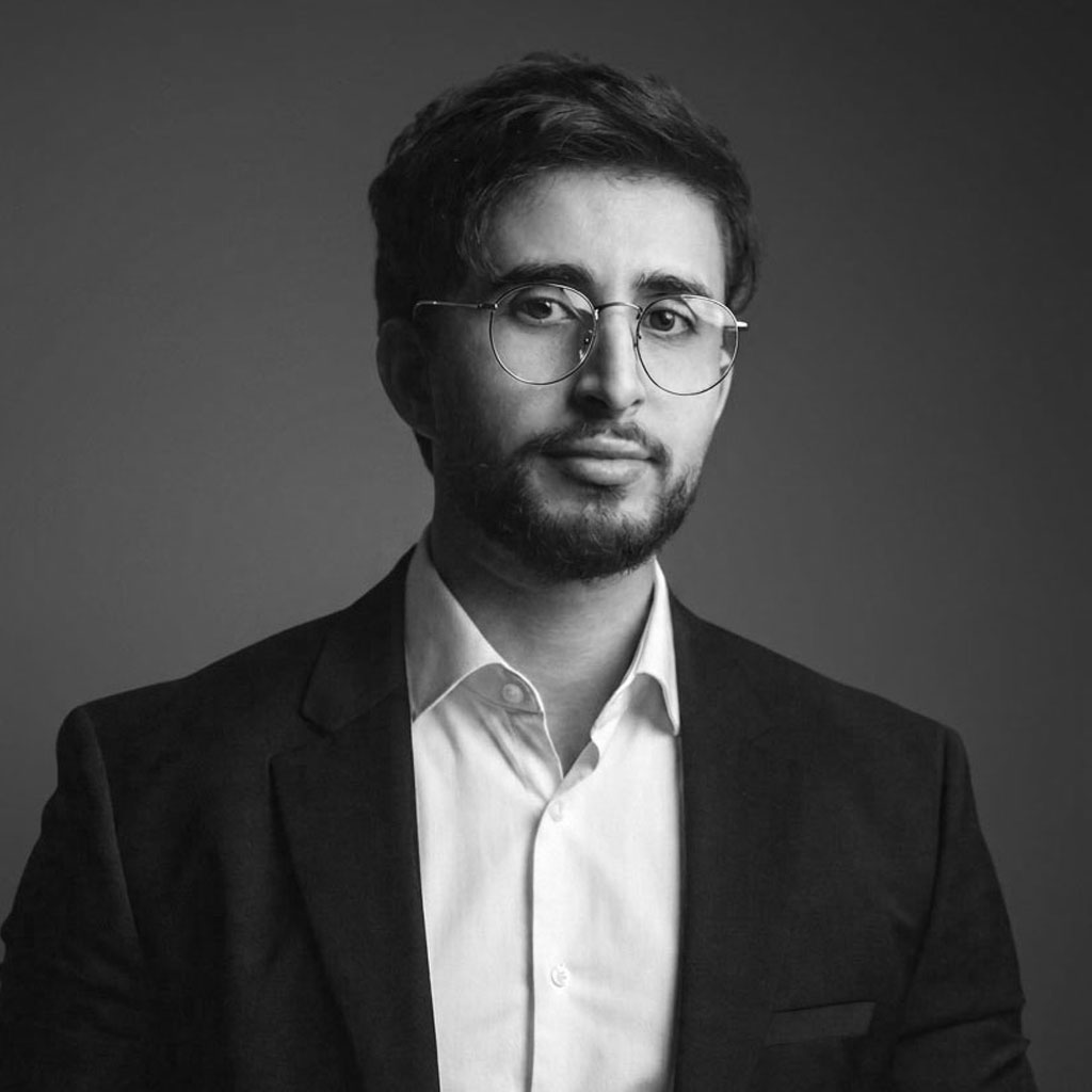 Black-and-white portrait of man in suit and glasses