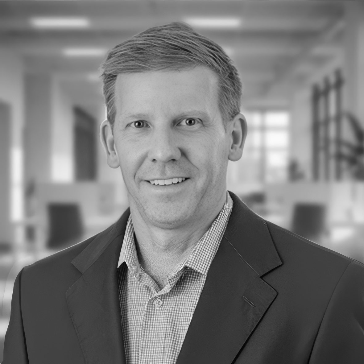 Professional headshot of smiling man in office