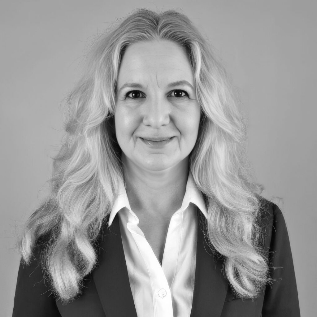 Black-and-white professional headshot of smiling woman