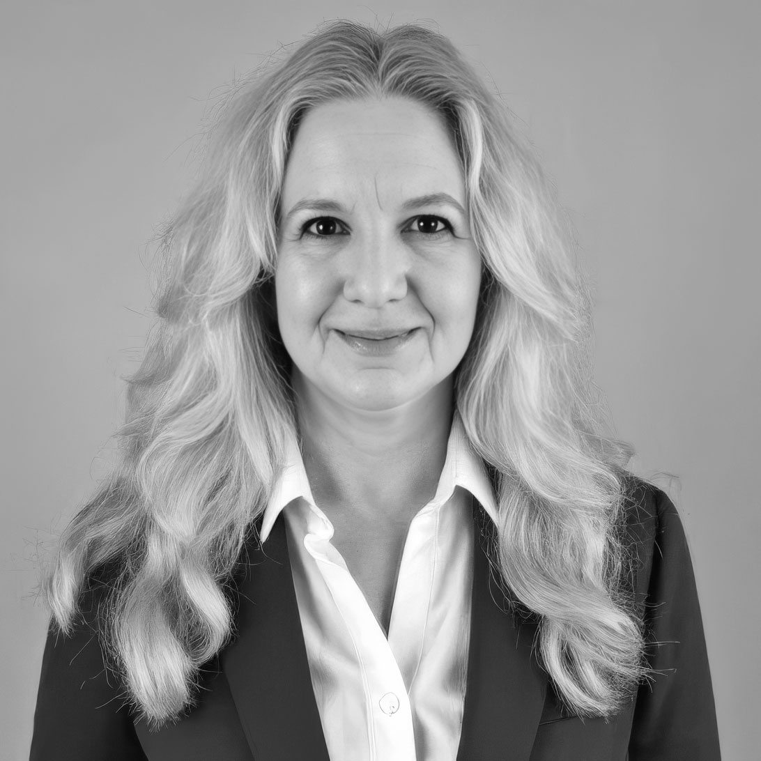 Black-and-white professional headshot of smiling woman