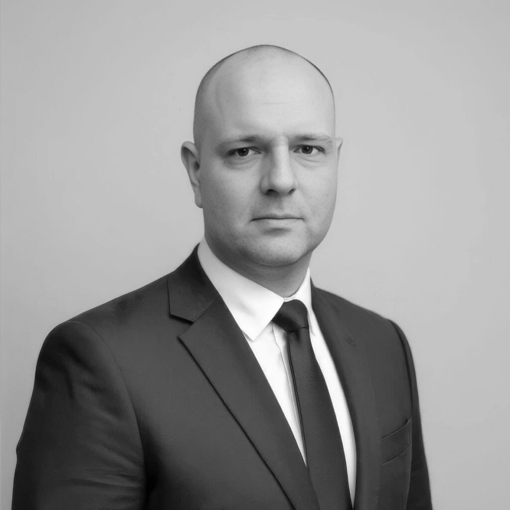 Black-and-white portrait of bald man in suit