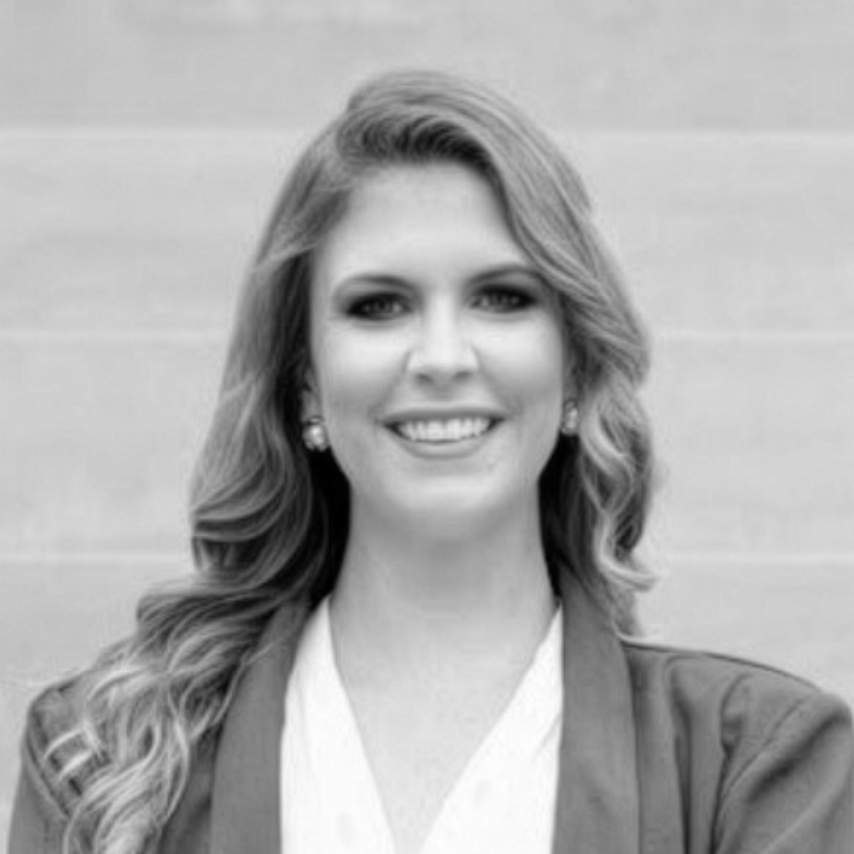 Black-and-white portrait of smiling professional woman