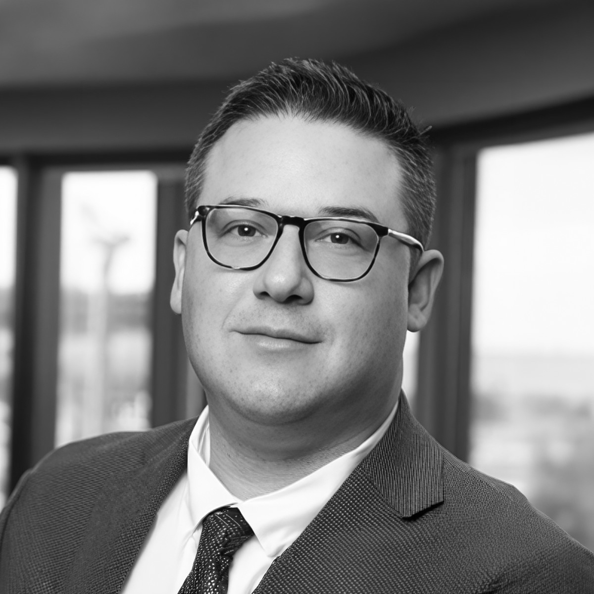 Black-and-white professional headshot of Stephen Putnoki-Higgins